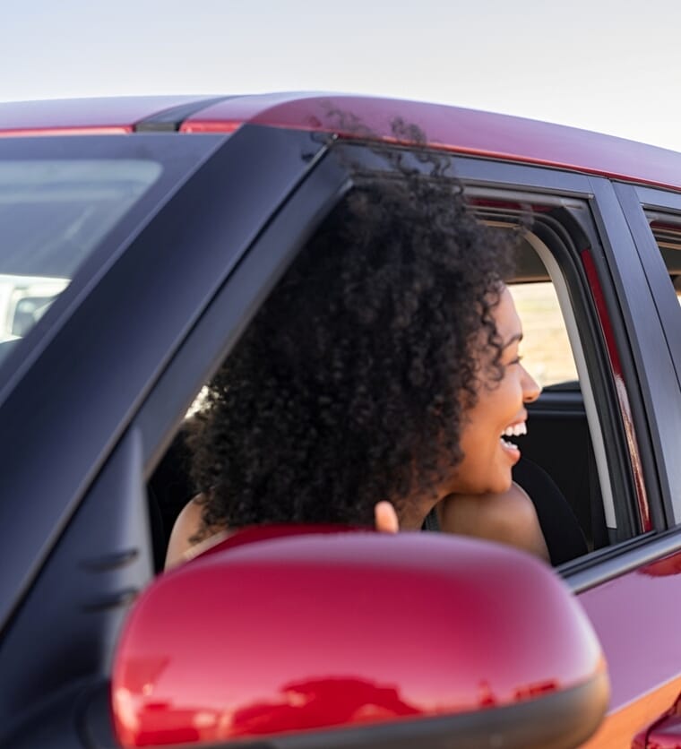 Smiling Woman Looking Outside Car