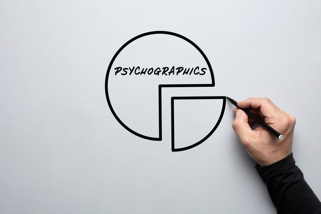 Male hand drawing a pie chart with the word psychographics